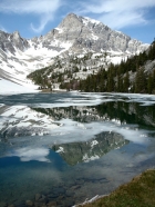 Mount Idaho reflecting in a partially frozen Merriam Lake.