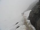 Climbing up the snow into the fog with our 55 pound packs.