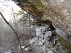 Trail passing under some overhanging rock.