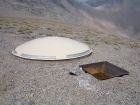 A weather station of some kind sits on the saddle between Wet Peak and South Wet Peak. The disk is about 7' in diameter.